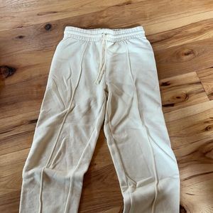 Adorable artists branded sweatpants in light yellow.